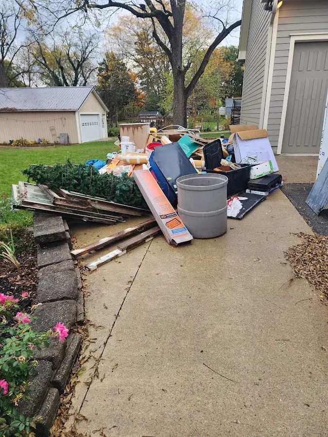 Dumpster being loaded with debris for Estate Cleanout Dumpster Rental in Le Mars